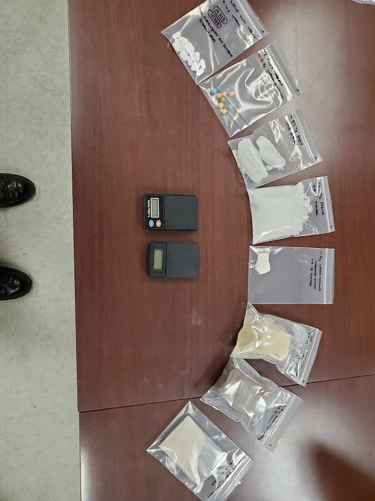 An assortment of narcotics found during a search of Jackson's car, along with two scale