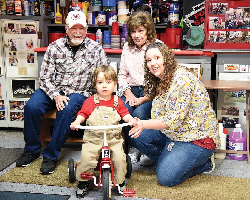 Tom McCown, the owner of Cartillac Bike, sits with Noah Heather, 2, Noah&rsquo;s mother Candice Heather and grandmother Mary Heather recently at his shop. McCown met the family by accident and restored a trike belonging to Noah&rsquo;s father, Daniel, for him. Noah was born June 4, 2019, with hypoplastic left heart syndrome.