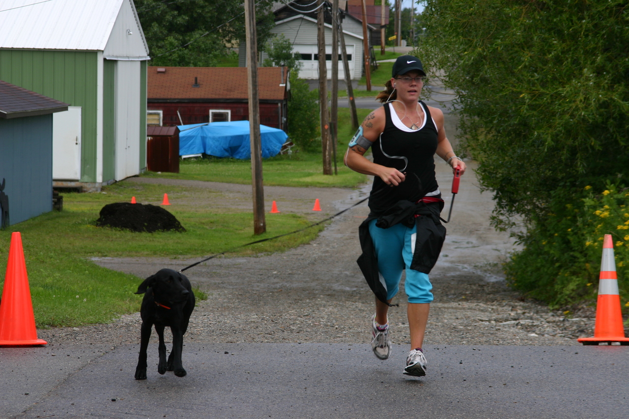 Beth Reichensperger crosses the finish line with a little help from a friend