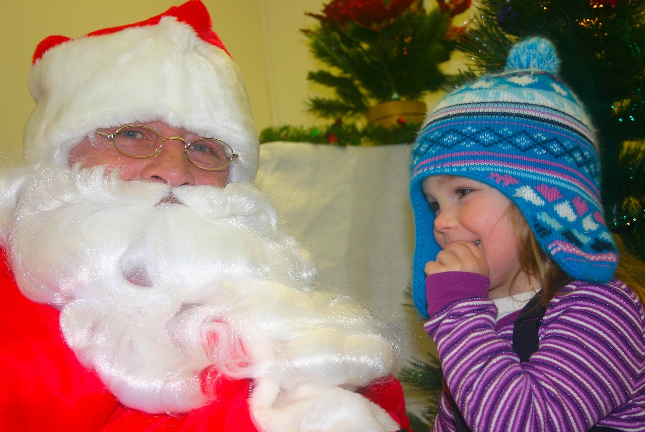 Santa hears the Christmas wishes of a little girl during Orr's Snow City celebration.