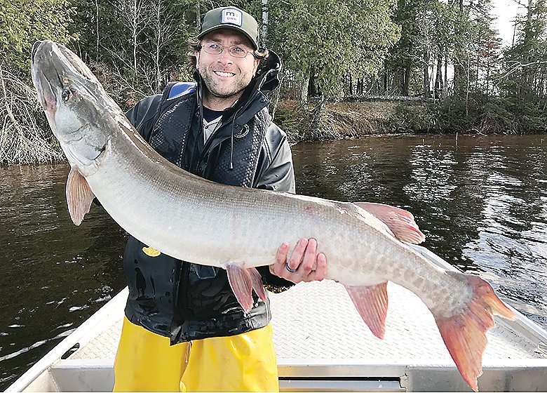 DNR large lake specialist Matt Hennen holds one of the giant musky 
captured as part of the annual fish survy on Lake Vermilion.