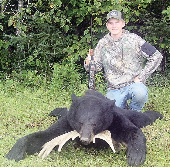 Sixteen-year-old Troy Ray
poses with the 326-pound bear he shot during the first week of the 2020 bear hunt.