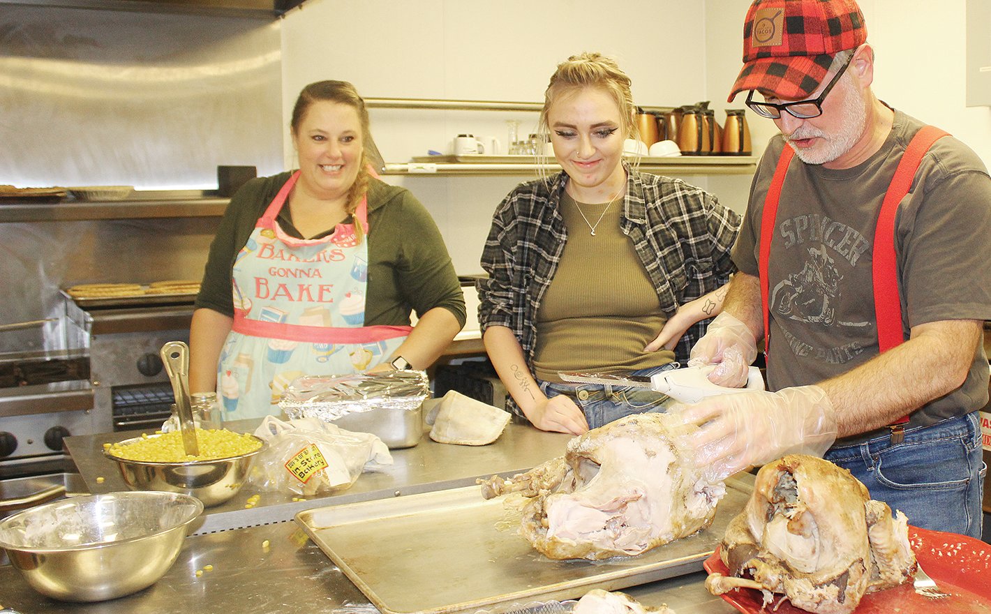 Kitchen volunteers Stacy Gallus, Dakota Hanninen, and Al White help prepare a Thanksgiving feast at Vermilion Country School.
