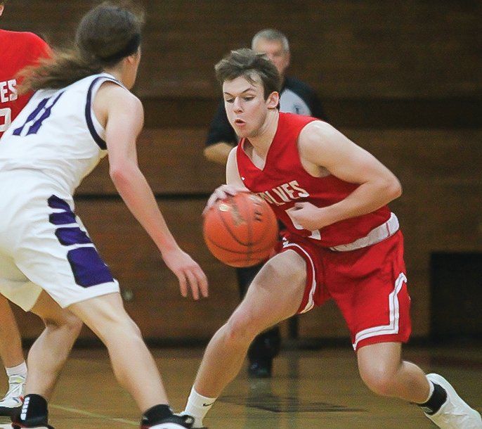 Harry Simons pivots as he works the ball down the court against Hill City on Saturday.