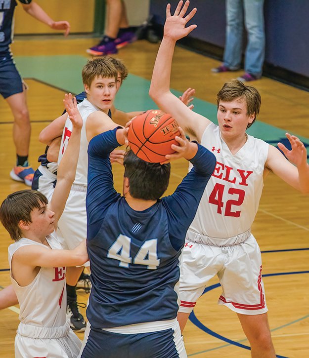 Ely’s Jack Davies, left, and Erron Anderson harass Grizzlies’ center Sean Morrison.