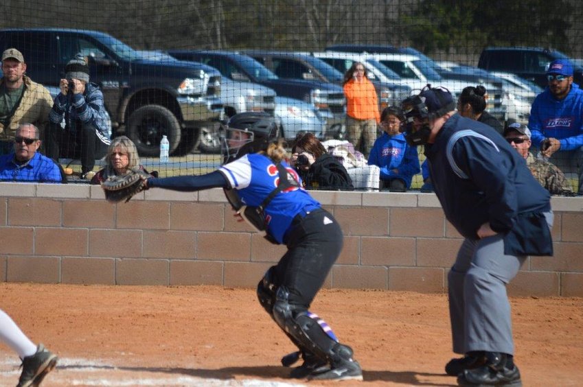 Quitman’s Kynlee Love makes a stop from her catcher’s position. She delivered the winning hit in a 5-3 win over Bowie Saturday.