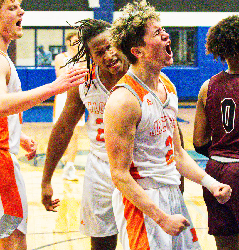 From left, Dawson Pendergrass, Trevion Sneed and T.J. Moreland react enthusiastically to Moreland scoring two points put Mineola ahead by 12 in the fourth quarter while drawing a foul on Jefferson.