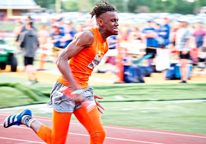 Jamarcus Kennedy runs the 3rd leg of the 4x200 meter relay for the Yellowjackets, who set a new school record with a time of 1:30.57 seconds.