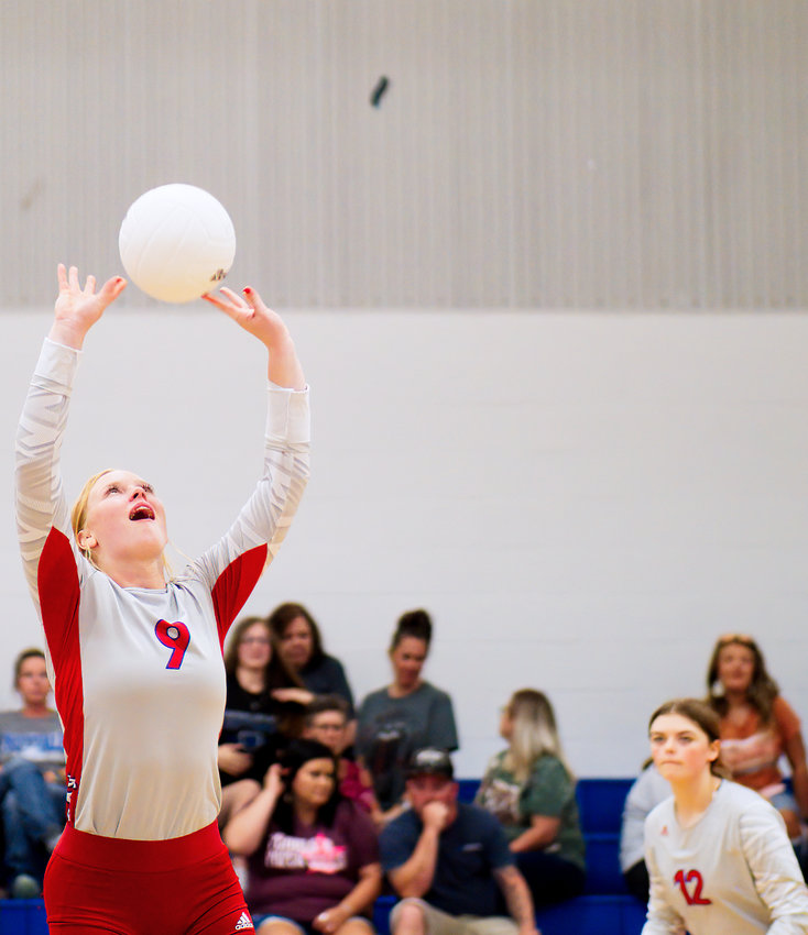 Kaylee Anglin sets the ball as Alexis Wilmut anticipates going to the ball for a kill.