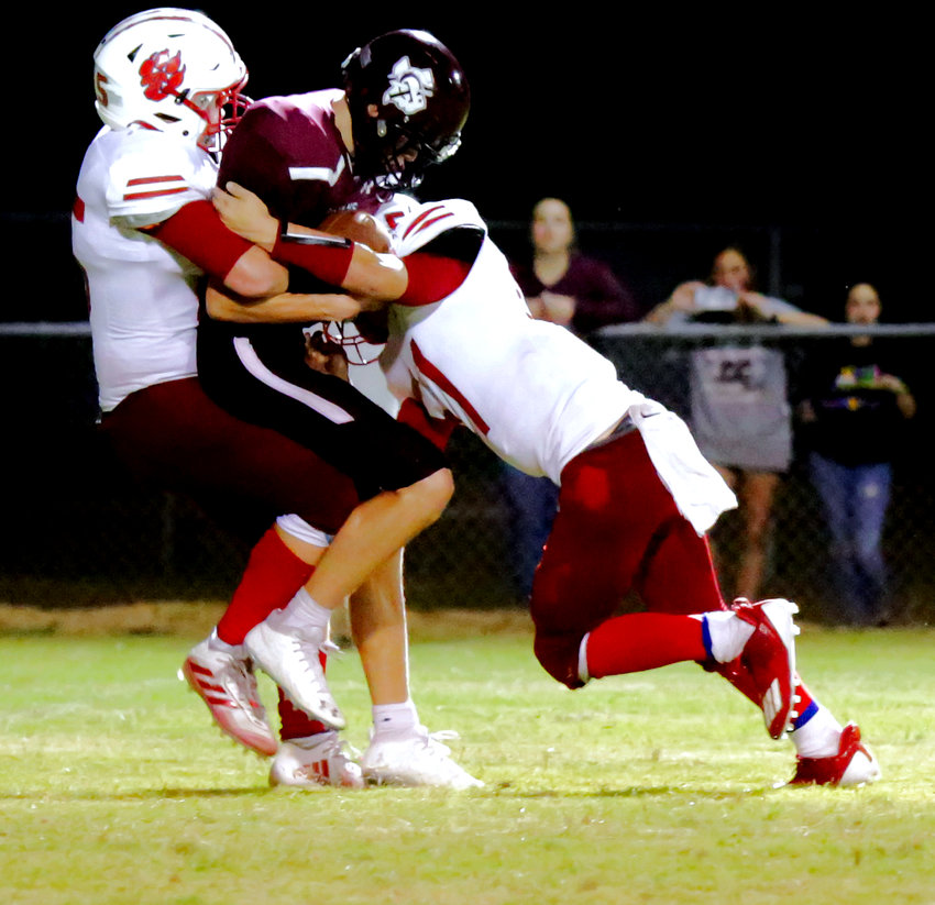 Michael Gaskill (left) assisted by Jason Langston makes the game-sealing sack of the Cumby quarterback on a fourth down to preserve the win.