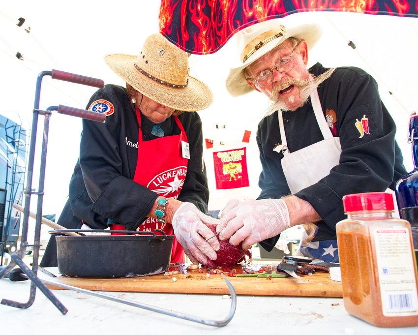 Amelia Taylor and Wes Stigen of Gilmer prepare Argentinian meat.