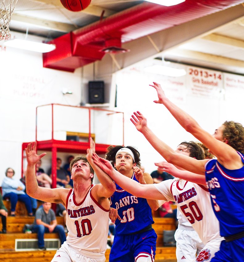 From left, Blake Weissert, Thomas Sebedra, Gavin Dailey and Brady Floyd fight for position to nab a rebound.